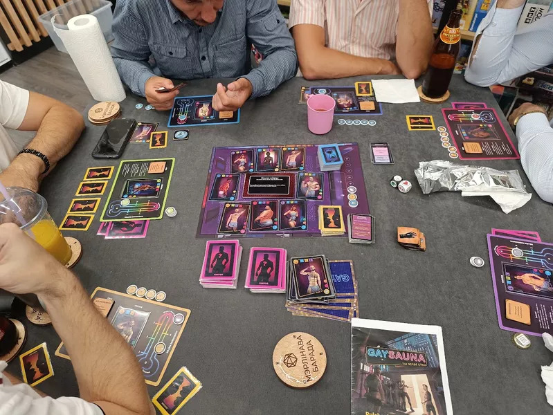 Six people playing the Gay Sauna board game